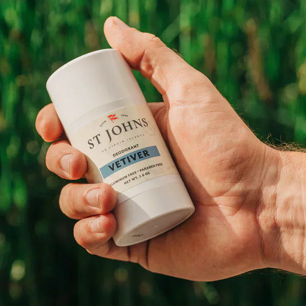 A hand holds Vetiver Aluminum-free, paraben-free deodorant from St Johns.